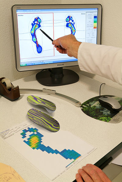 Doctor preparing orthopedic insoles for a patient